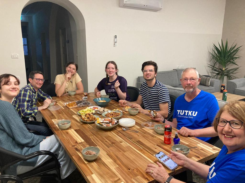 A photo of Brian Murray enjoying a meal with other SERVE Nazareth volunteers in the Doctor's House.